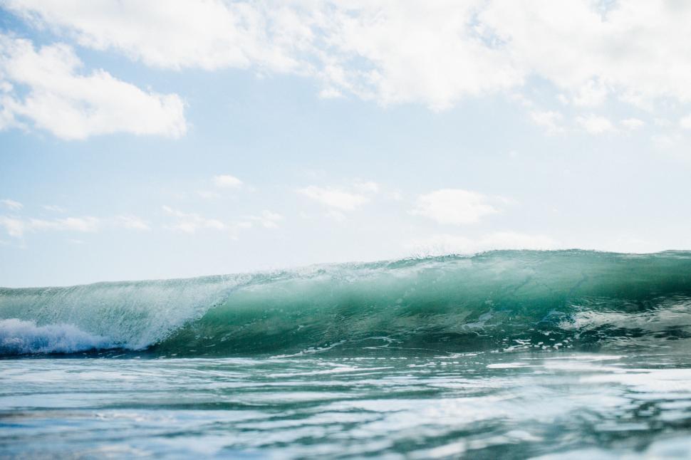 Free Image of Man Riding Wave on Surfboard 