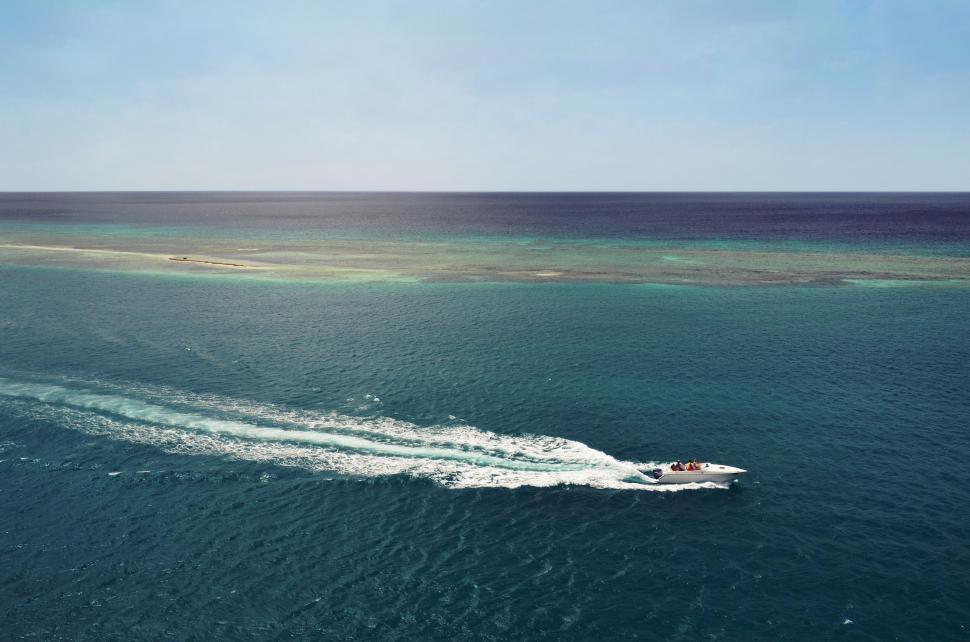 Free Image of Small Boat Crossing Vast Ocean 