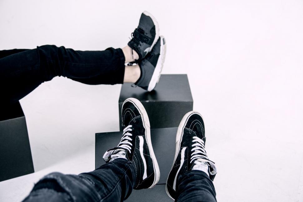 Free Image of Person Sitting on Top of Black and White Box 