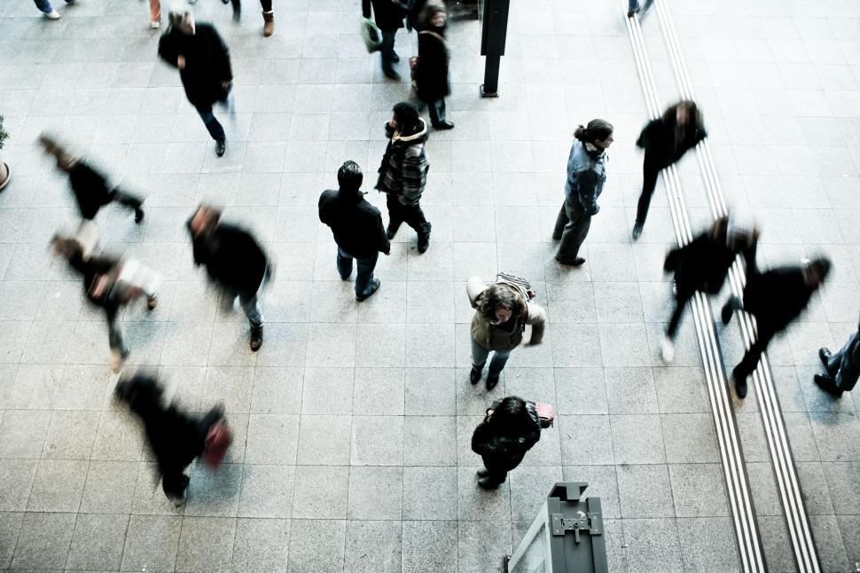 Free Image of Group of People Walking Down a Sidewalk 