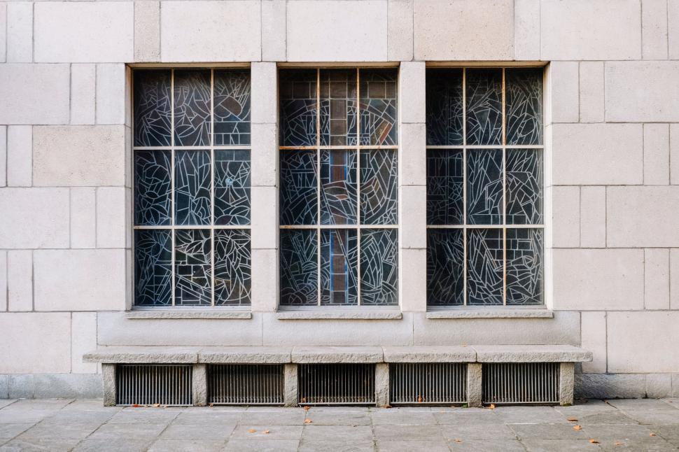 Free Image of White Building With Three Windows and Bench 