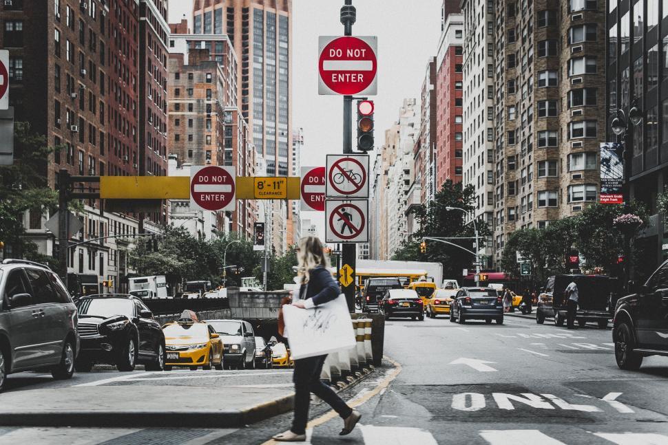 Free Image of Woman Crossing Street in Busy City 
