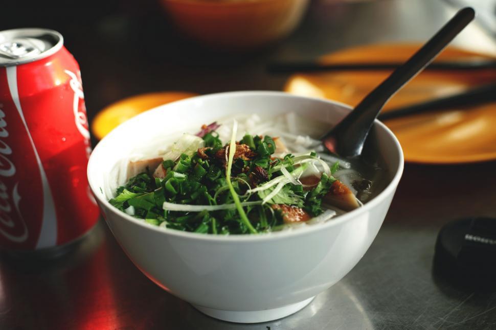 Free Image of Bowl of Food and Soda Can on Table 