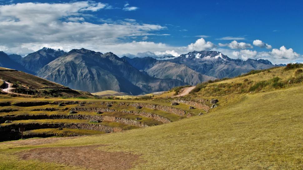 Free Image of Grassy Field With Mountains in Background 