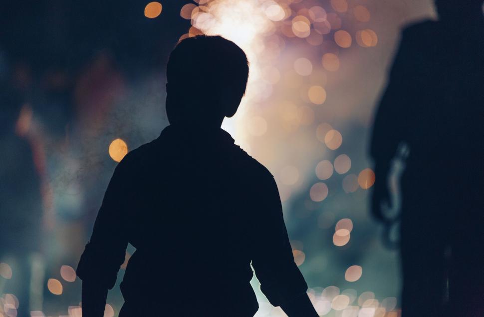Free Image of Silhouette of Person Walking Down Night Street 