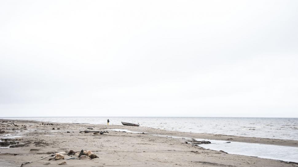 Free Image of Boat Resting on Beach by Ocean 