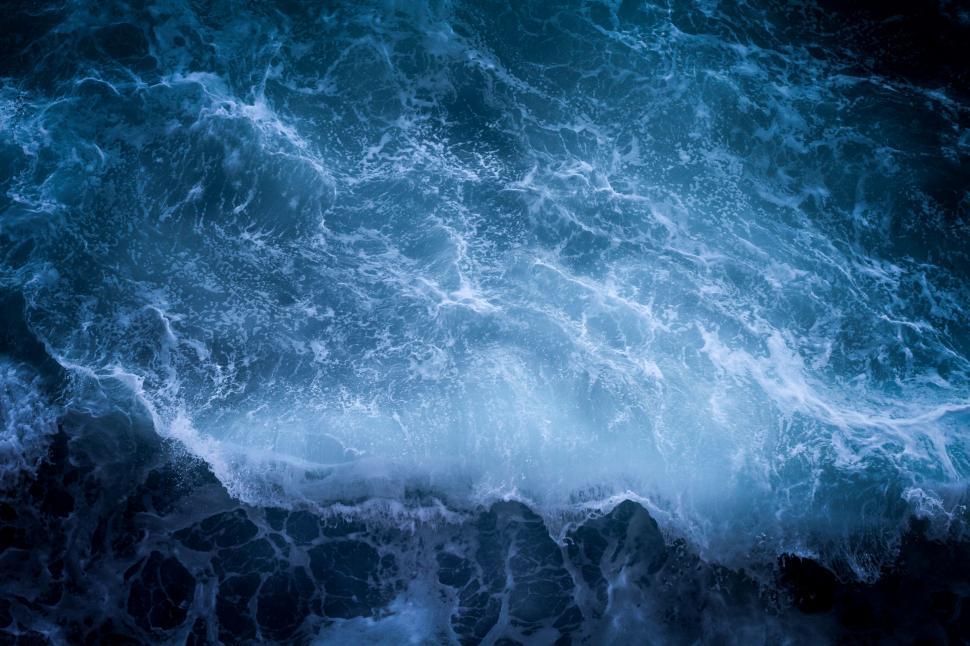 Free Image of Rocky Shoreline Surrounding Vast Body of Water 
