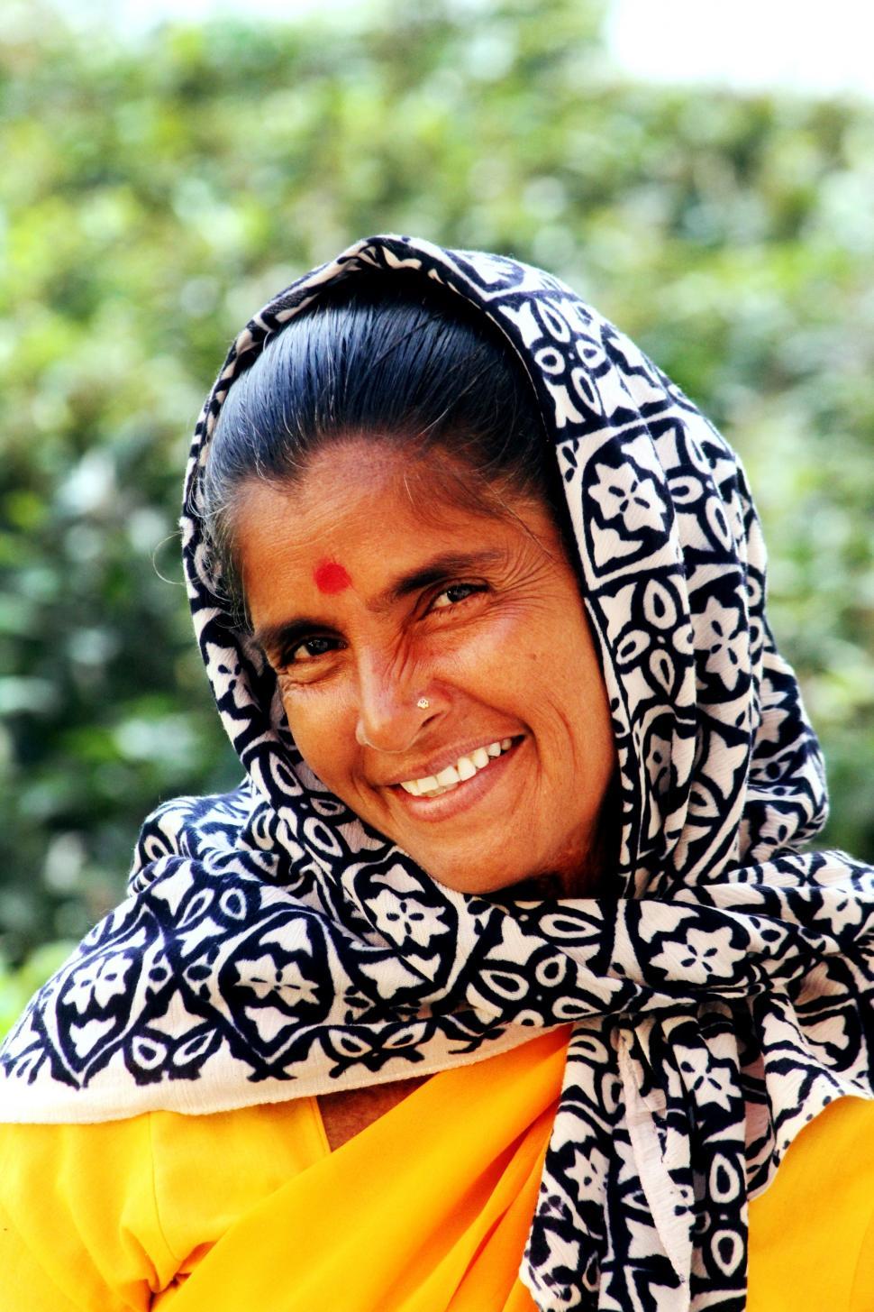 Free Image of Smiling Woman in Yellow Outfit and Black and White Scarf 