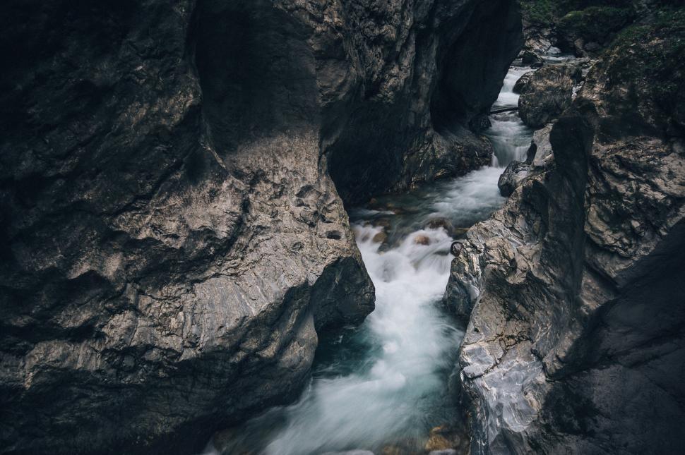Free Image of Water Stream Flowing Between Two Large Rocks 