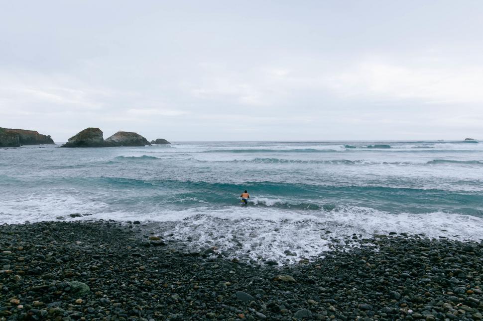 Free Image of Person Riding Surfboard on Wave in Ocean 