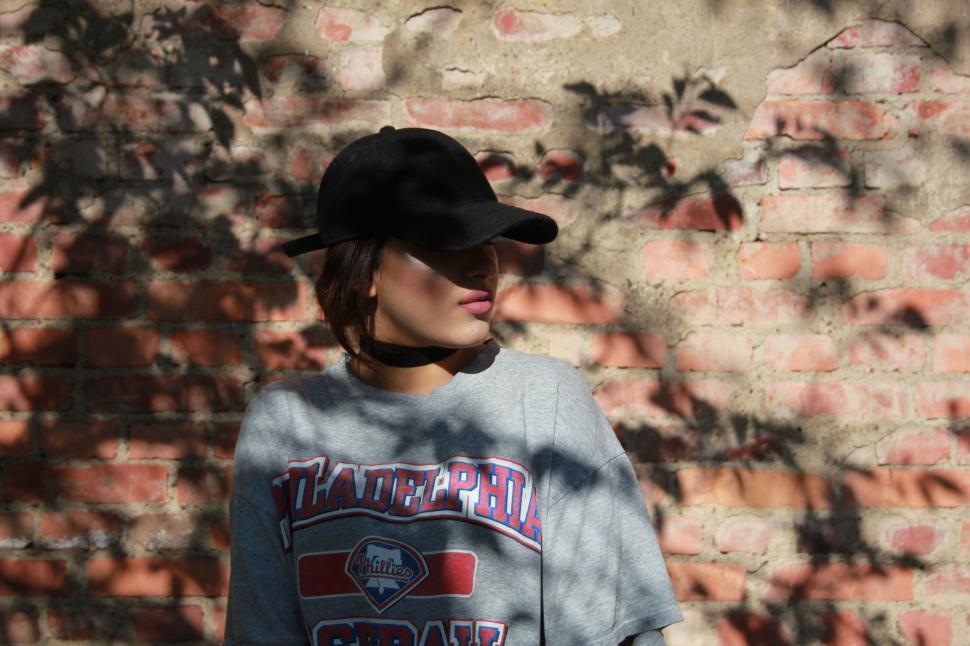 Free Image of Person Standing in Front of Brick Wall 