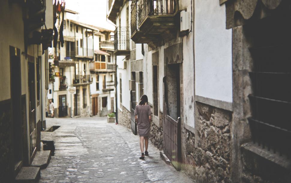Free Image of Person Walking Down a Narrow Alleyway 