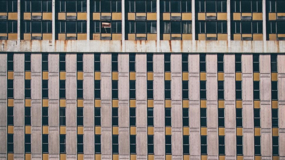 Free Image of Tall Building With Windows and Bars 