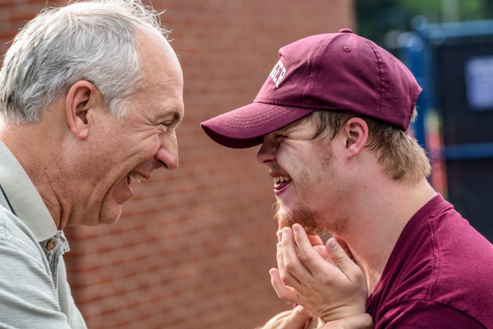 Free Image of Older Man and Younger Man Laughing Together 