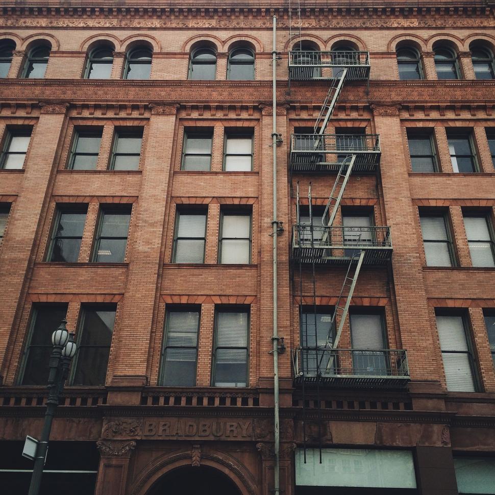 Free Image of Tall Brick Building With Fire Escape 