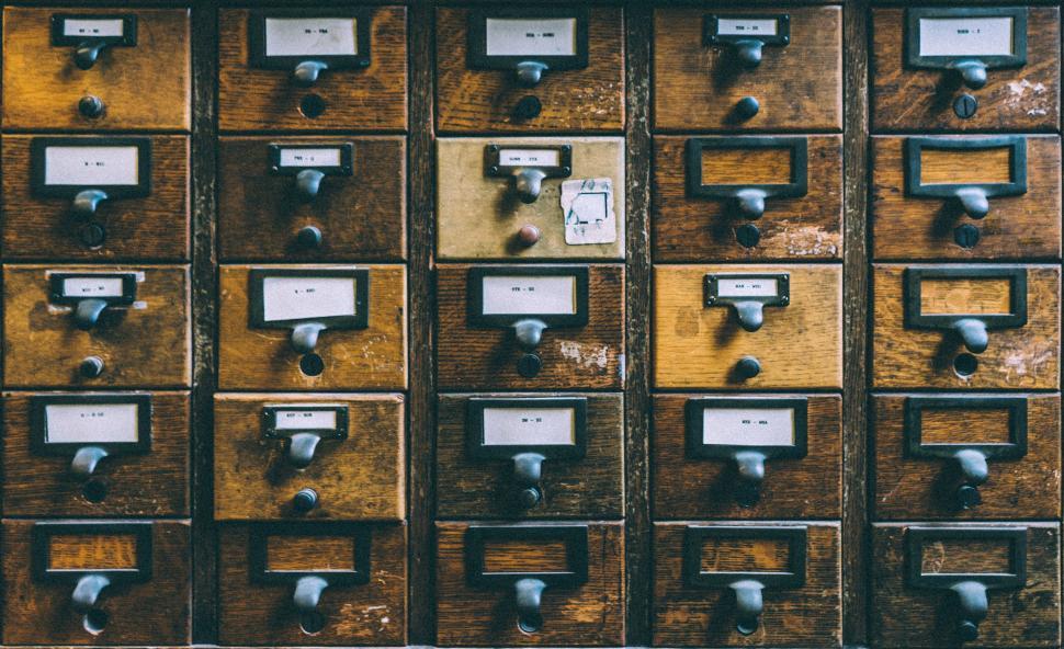 Free Image of Array of Wooden Drawers With Metal Knobs 