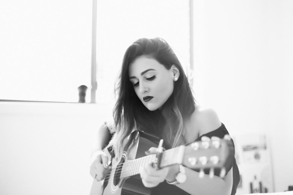 Free Image of Woman Playing Guitar in Room 