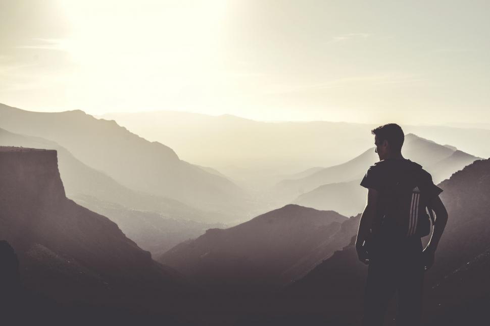 Free Image of Man Standing on Mountain Overlooking Valley 