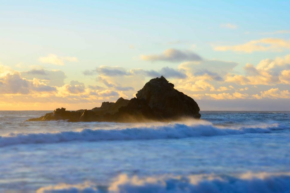 Free Image of Large Rock in Middle of Body of Water 