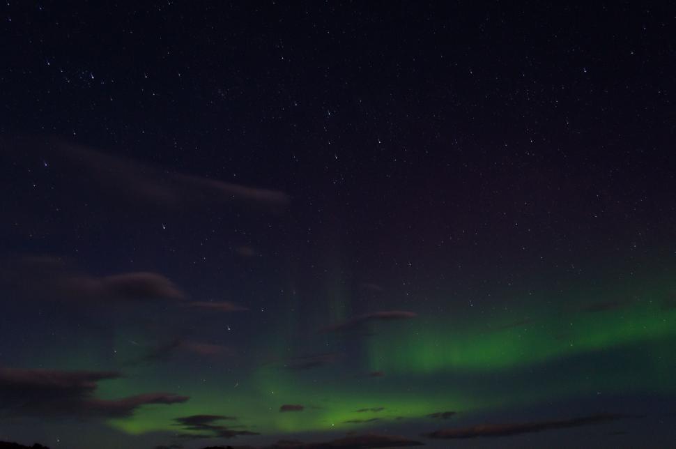 Free Image of Green and Black Sky Filled With Clouds 