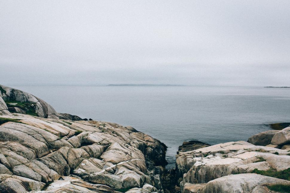 Free Image of Rocky Shoreline Next to Large Body of Water 
