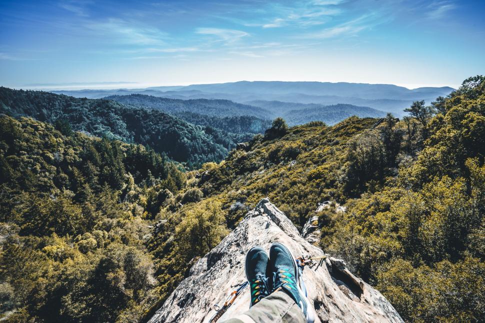 Free Image of Person Standing on Top of Rock in Forest 