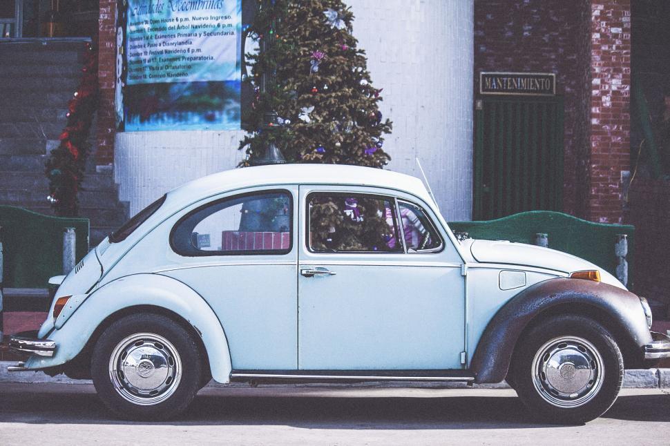 Free Image of Small White Car Parked on Side of Road 