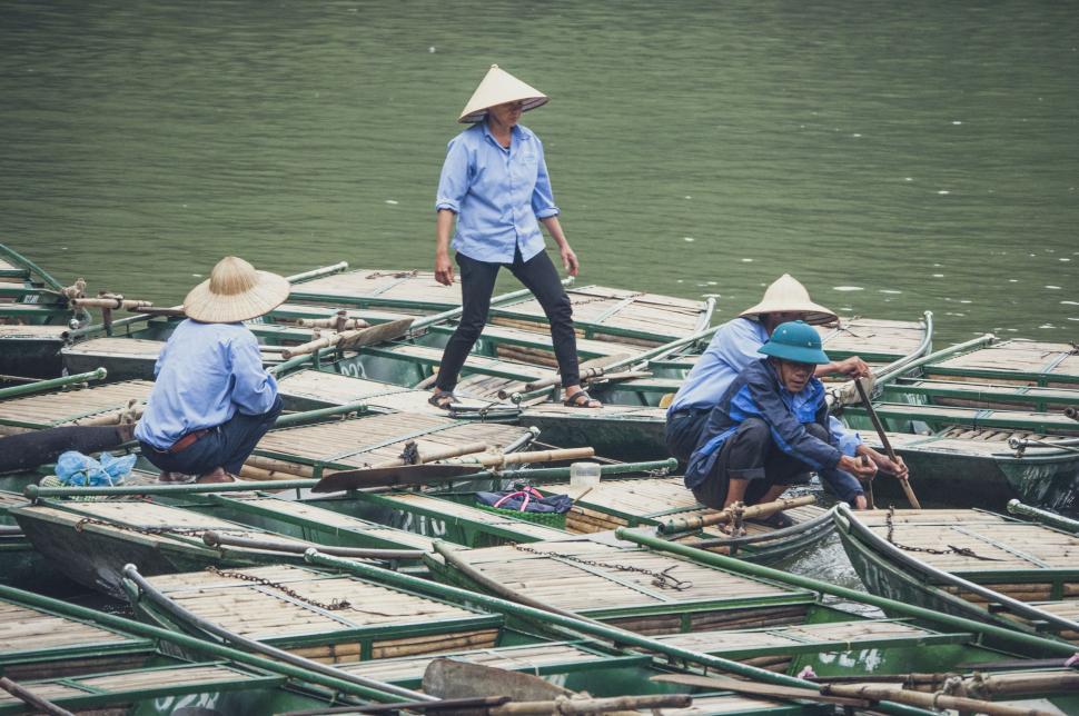 Free Image of Group of People Sitting on Top of Small Boats 