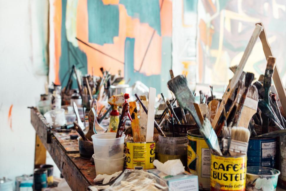 Free Image of Wooden Table Covered With Paint and Brushes 