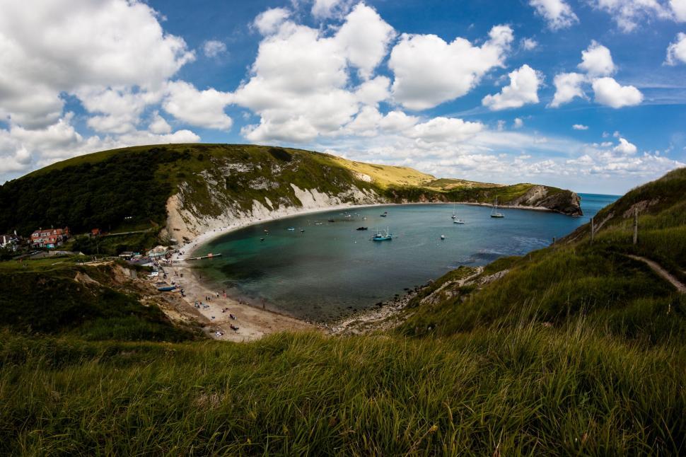 Free Image of Tranquil Lake Surrounded by Lush Green Hillside 