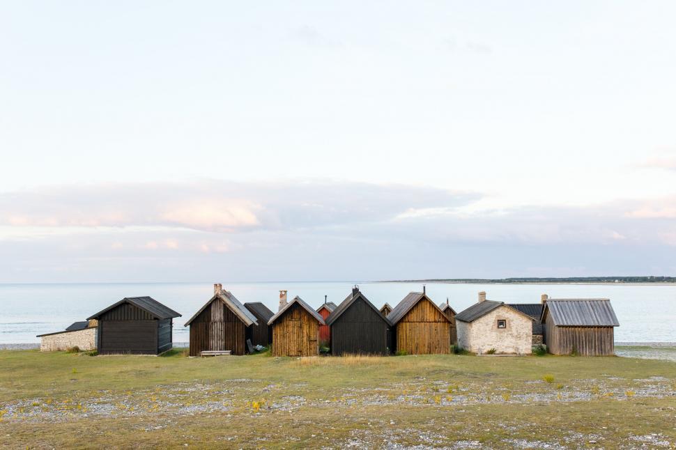 Free Image of Row of Small Houses on Grass Covered Field 