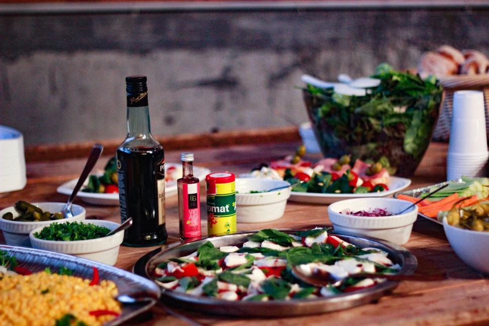 Free Image of Wooden Table Covered With Plates of Food 