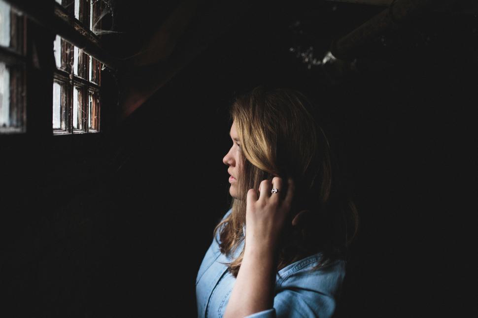 Free Image of Woman Talking on Cell Phone in Dark Room 