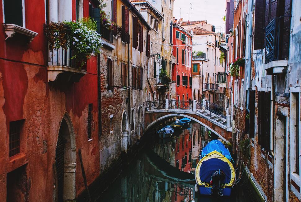 Free Image of Small Boat Navigating Narrow Canal 