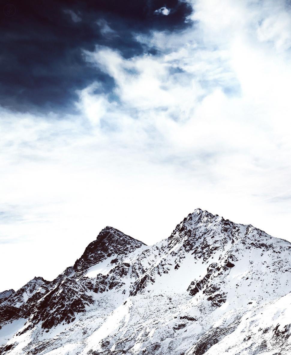 Free Image of Snow Covered Mountain Under Cloudy Sky 