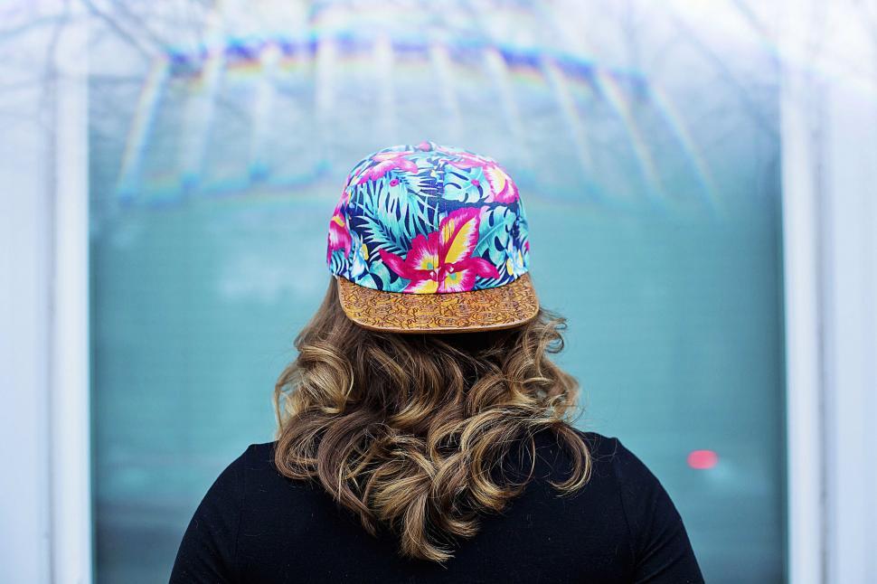 Free Image of Woman Wearing Hat With Tropical Print 