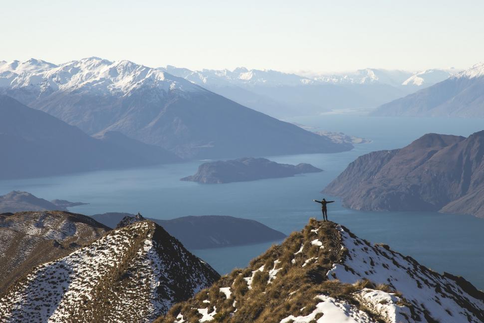 Free Image of Person Standing on Snow-Covered Mountain Top 