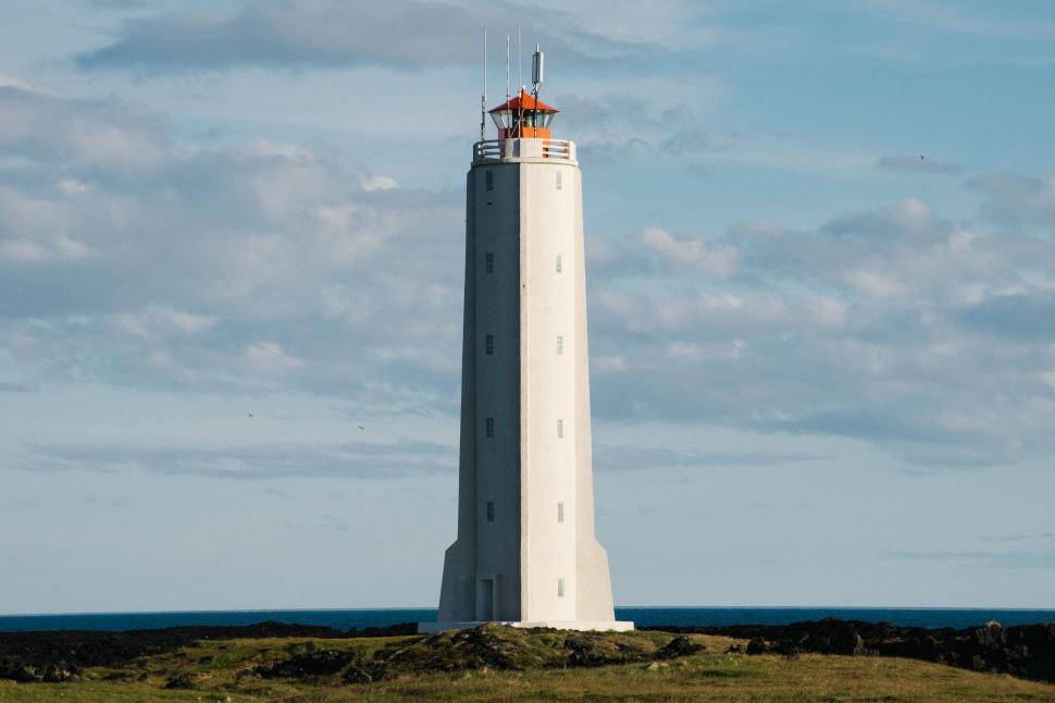 Free Image of Tall White Tower on Lush Green Field 