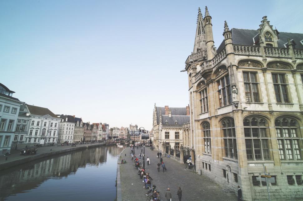 Free Image of Group of People Riding Bikes Along River 
