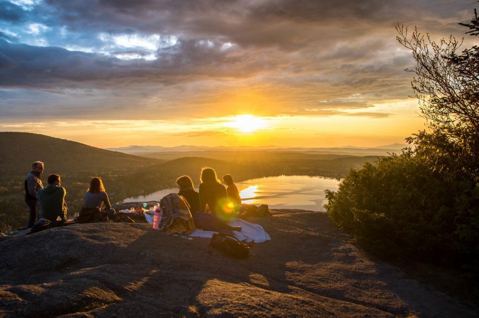 Free Image of Group of People Sitting on Top of a Mountain 