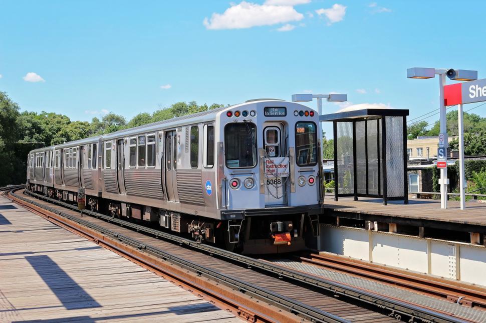 Free Image of Silver Train Passing Platform Along Train Tracks 