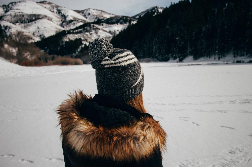 Free Image of Person Standing in Snow With Mountains in Background 