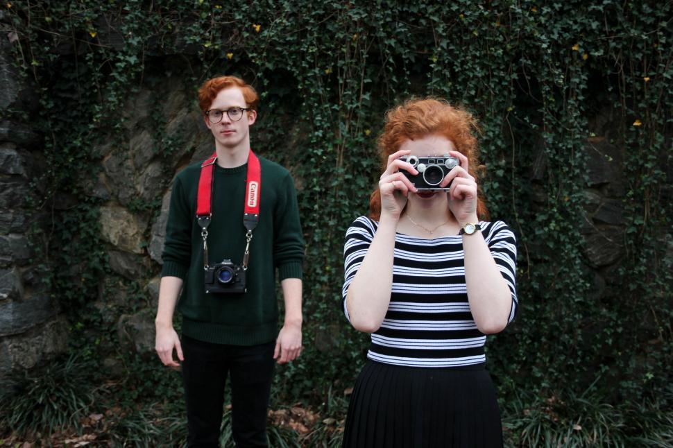 Free Image of Woman Taking Picture of Man With Camera 