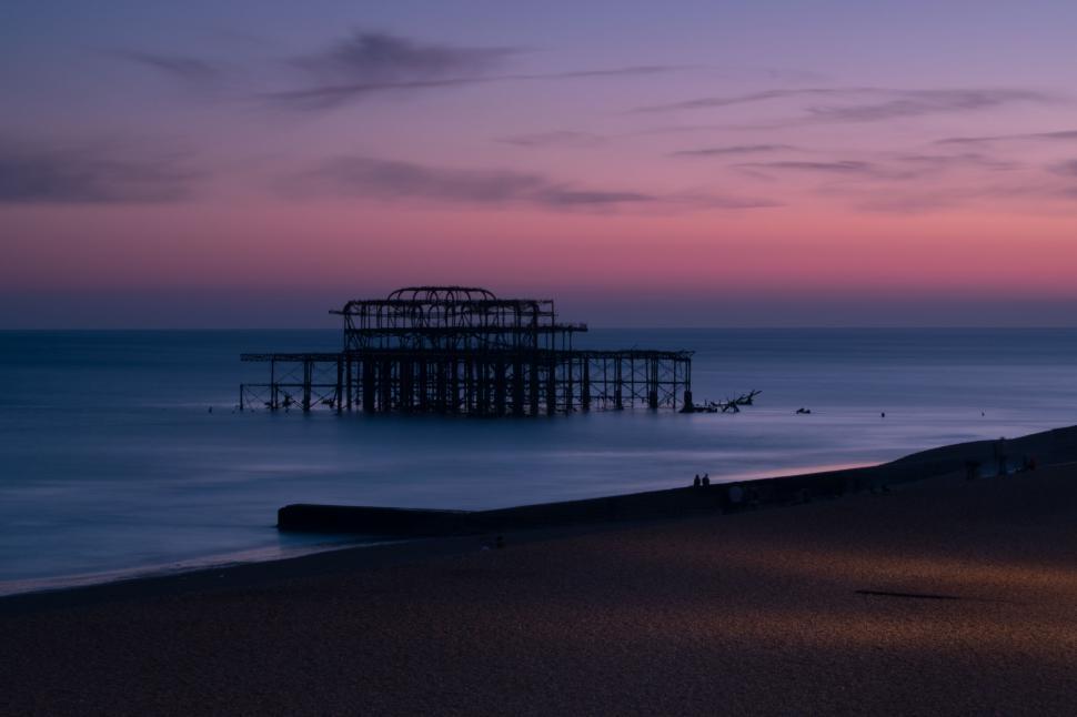 Free Image of Large Structure Overlooking Beach by the Ocean 