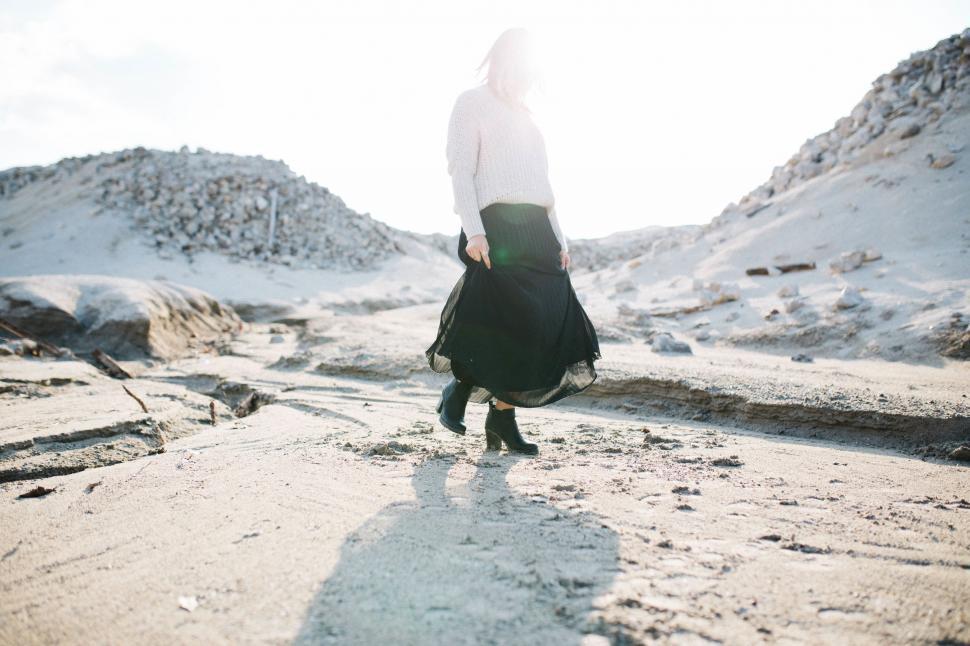Free Image of Person Standing in the Middle of a Snowy Field 