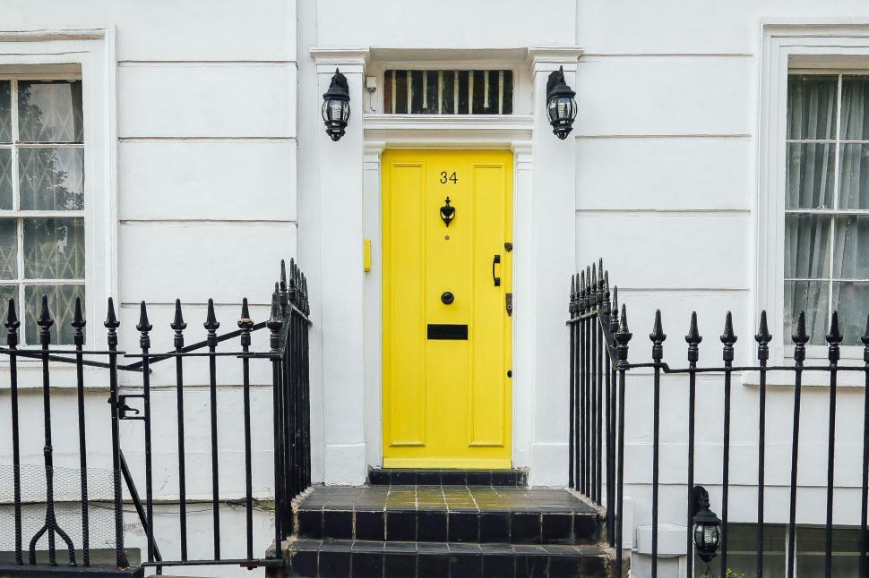 Free Image of Yellow Door in Front of Black Fence 