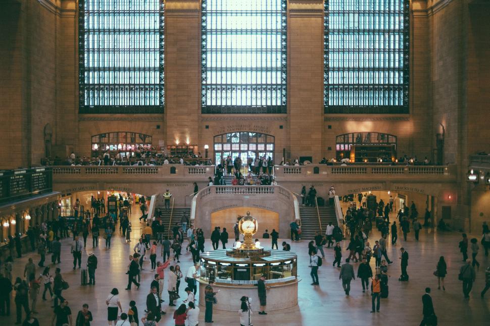 Free Image of Group of People Walking Around Train Station 
