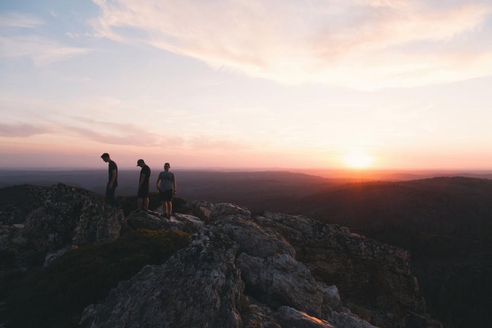 Free Image of Group of People Standing on Top of a Mountain 