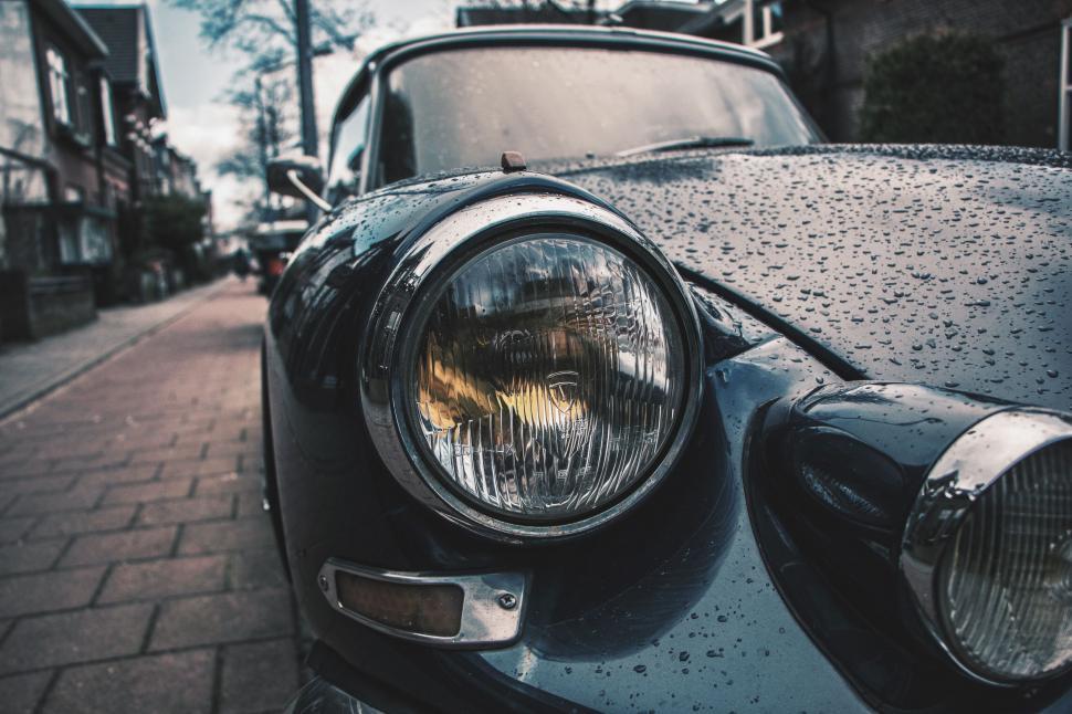 Free Image of Close Up of Car Headlight on City Street 