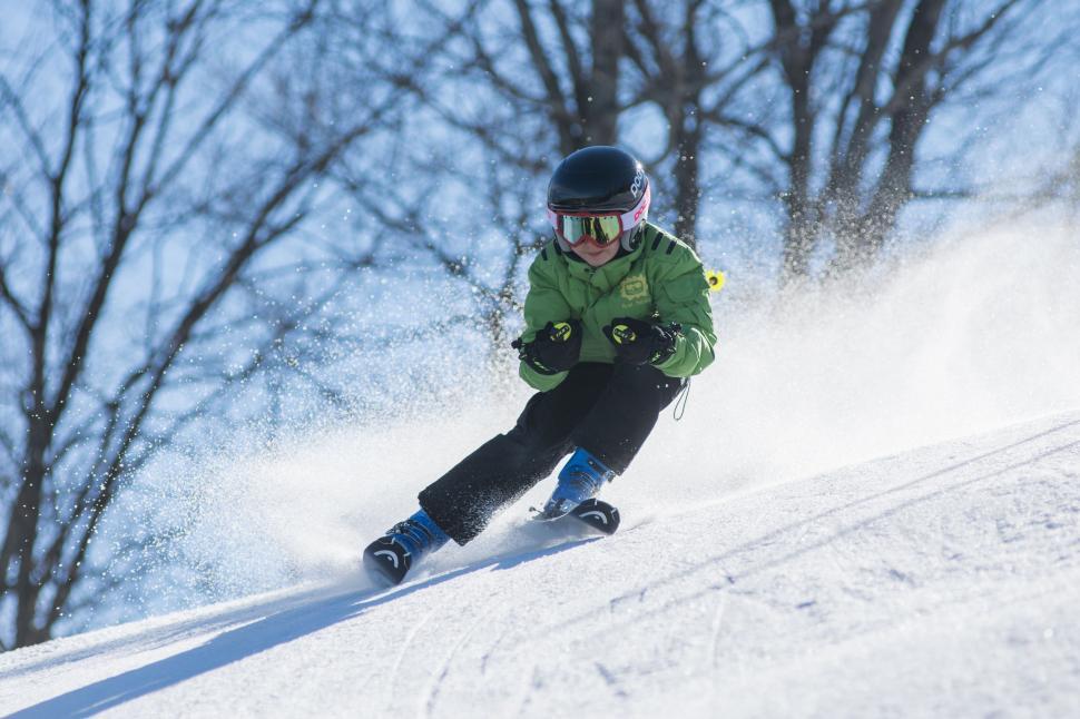 Free Image of Person Snowboarding Down Snow Covered Slope 